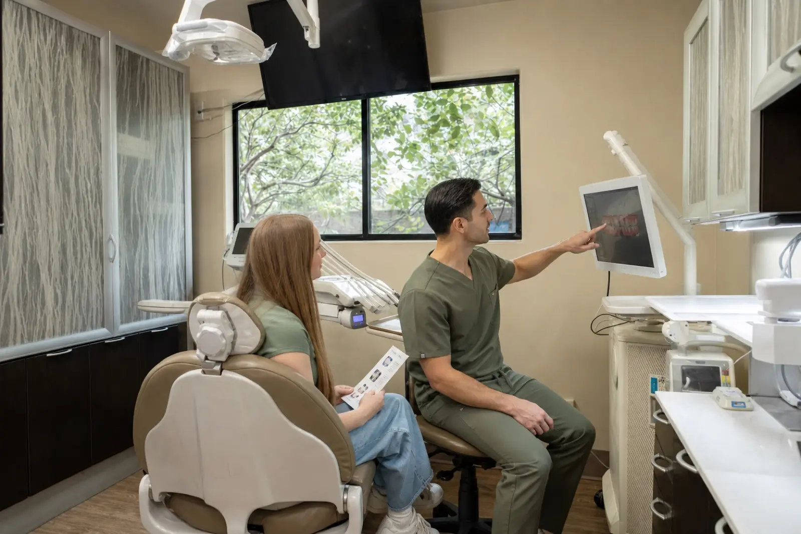 A dentist explaining a treatment plan to a patient