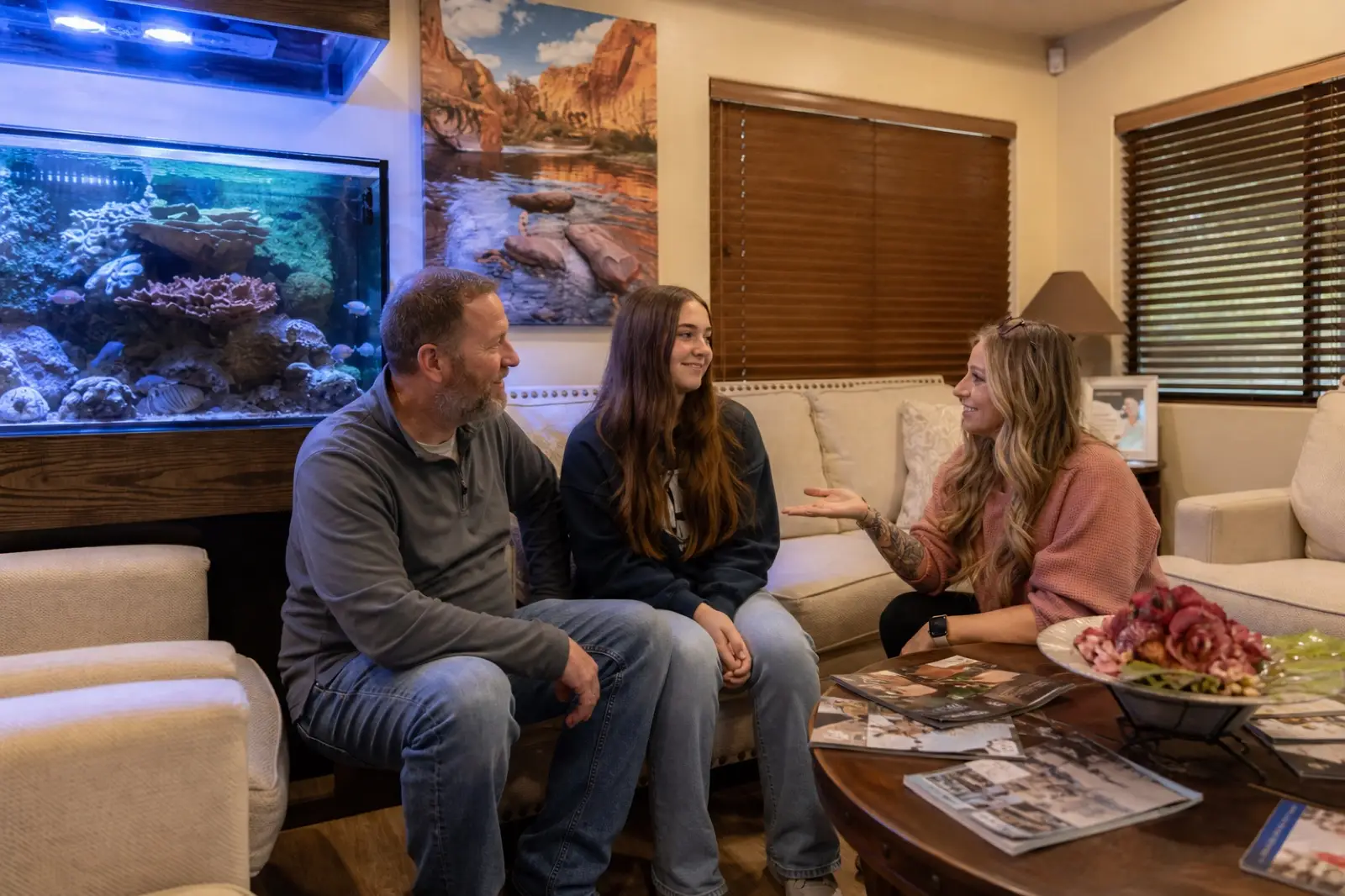 A family talking with the team in the Red Cliffs Dental lobby